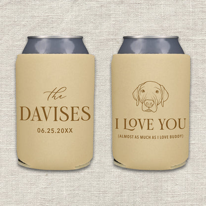 Two personalized beer can coolers shown side by side on a textured light beige fabric background. The left can cooler is camel with brown text featuring the couples' last name and wedding date. The right can cooler is camel with brown text and features a portrait of their dog and the words "I love you almost as much as I love the dog."