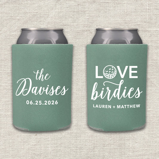Two willow green can coolers with personalized text that says "Love Birdies" on a textured beige background