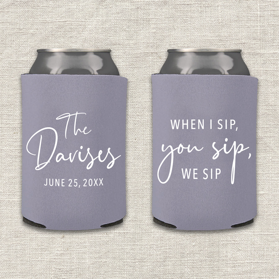 Two lilac gray can coolers with personalized text that says "When I sip, you sip, we sip" on a textured surface